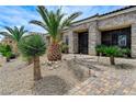 Elegant front entrance with wrought iron gate and stone accents at 6971 Moaning Cavern St, Las Vegas, NV 89131
