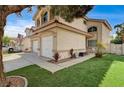 Charming two-story home with a three-car garage, lush landscaping, and a well-manicured lawn at 947 Rainbow Rock St, Las Vegas, NV 89123