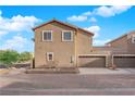 The rear of the home features a two-car garage and desert landscaping at 963 Sable Chase Pl, Henderson, NV 89011