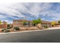 View of the front of a single-story home with a three-car garage and desert landscaping at 9731 Addie Meadow Ct, Las Vegas, NV 89149