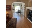 Open dining room with a glass-top table, leading to a well-lit kitchen and patio at 976 Dancing Vines Ave, Las Vegas, NV 89183