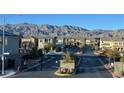 Gated community street view with mountain views in the background at 1027 Brilliant Meadow Ave, North Las Vegas, NV 89086