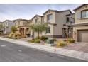 Street view of multiple two-story homes with neutral exteriors and well-manicured landscaping at 10376 Sadie Blake Ave, Las Vegas, NV 89166