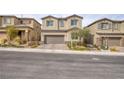 Inviting two-story home with desert landscaping, paved driveway, and two car garage at 10376 Sadie Blake Ave, Las Vegas, NV 89166
