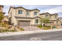 Attractive two-story home featuring a brick driveway, a two-car garage and manicured front yard at 10376 Sadie Blake Ave, Las Vegas, NV 89166