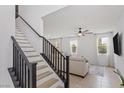 Bright staircase leading to the living room area with fresh white walls and sleek, modern finishes at 10376 Sadie Blake Ave, Las Vegas, NV 89166