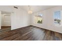 Bright dining room features wood-look flooring, chandelier, and natural light at 10505 Linden Wood Ct, Las Vegas, NV 89134