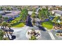 Aerial view of the gated community entrance with lush landscaping and mature trees at 11072 Pentland Downs St, Las Vegas, NV 89141