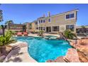 Inviting backyard pool and spa area with rock features, poolside lounge, and patio at 11072 Pentland Downs St, Las Vegas, NV 89141