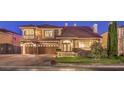 Stunning two-story stone home featuring a three-car garage and meticulous landscaping at 11072 Pentland Downs St, Las Vegas, NV 89141