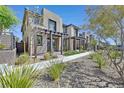 Beautiful home featuring modern architecture, desert landscaping and striking curb appeal under a clear blue sky at 11705 Bearpaw Meadow Ave, Las Vegas, NV 89138