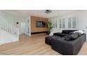 Spacious living room with wood-look flooring, modern decor, and lots of natural light at 12346 Valley Chase Ave, Las Vegas, NV 89138