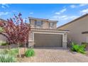 Charming two-story home featuring a tiled roof, a two-car garage, and a brick driveway at 1606 Wild Grain Ave, North Las Vegas, NV 89086
