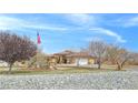 Traditional home featuring a beautiful lawn, large driveway, and flagpole with American flag at 1830 E Fuchsia St, Pahrump, NV 89048