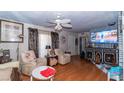 Comfortable living room with wood floors, patterned curtains, and a television set on a black entertainment center at 1908 Hassett Ave, Las Vegas, NV 89104