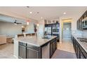 Modern kitchen with a large island, stainless steel appliances, and an open layout to the living area at 262 Inflection St, Henderson, NV 89011