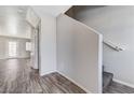 A bright entryway showcasing durable gray wood flooring and stairs leading to the upper level at 2621 Adelante Ave # 104, Las Vegas, NV 89106