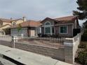 Inviting single story home with attached three-car garage, tile roof, and manicured desert landscaping at 3316 Cutty Sark St, Las Vegas, NV 89117