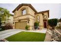 Two-story home featuring a two-car garage, arched windows, red front door and manicured lawn at 3916 Broad Meadow Ct, Las Vegas, NV 89129
