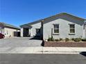 Charming home featuring desert landscaping, a three-car garage, and modern architectural details at 5518 Stormy Night Ct, Las Vegas, NV 89120