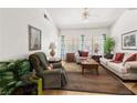Inviting living room with hardwood floors, large windows, and comfortable furnishings at 5709 Colwood Ln, Las Vegas, NV 89130