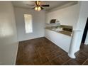 Eat-in kitchen area with tiled floor, window, granite countertops and ceiling fan at 601 Cabrillo Cir # 970, Henderson, NV 89015