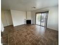 Bright living room featuring tiled floors, fireplace, and a sliding door to the balcony at 601 Cabrillo Cir # 970, Henderson, NV 89015