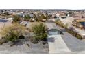 Aerial view of a single story home with a two car garage, surrounded by desert landscaping at 6860 Stubblefield Dr, Pahrump, NV 89061