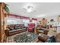 Spacious living room featuring comfortable seating, an area rug and tile flooring at 7741 Fruit Dove St, North Las Vegas, NV 89084