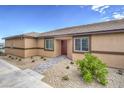 Single-story home with covered entry, stone walkway, desert landscaping, and neutral stucco at 7910 Pandora Sky St # 271, North Las Vegas, NV 89084