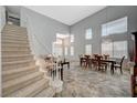 Bright open-concept living and dining area with staircase and natural light at 851 Brunellos Ave, Las Vegas, NV 89123