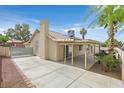 The covered back patio and spacious backyard offer a relaxing outdoor retreat with shade trees at 880 Autumn Canyon Way, Henderson, NV 89002