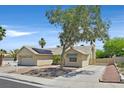 Inviting one-story home with a two-car garage, desert landscaping, solar panels, and mature shade trees at 880 Autumn Canyon Way, Henderson, NV 89002
