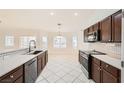 Bright kitchen featuring stainless steel appliances, dark cabinetry and modern white countertops at 917 Pigeon Forge Ave, Henderson, NV 89015