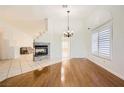 Bright, open living space featuring hardwood floors and a decorative fireplace with stone accents at 917 Pigeon Forge Ave, Henderson, NV 89015