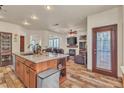 Open-concept living area with hardwood-style floors, a fireplace, and access to the outside at 9768 Northern Dancer Dr, Las Vegas, NV 89117