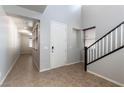 Bright entryway with tile flooring, a staircase, and natural light from a window at 9807 Sage Canyon St, Las Vegas, NV 89178