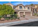 Attractive two-story home with a two-car garage, complemented by lush trees and meticulously maintained landscaping at 9967 Pipestone St, Las Vegas, NV 89141
