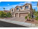 Charming two-story home featuring a two-car garage, inviting curb appeal, and manicured landscaping at 9967 Pipestone St, Las Vegas, NV 89141