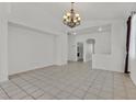 The expansive living room offers tile floors, neutral walls, and a view into other rooms at 100 Beaver Falls Ave, Las Vegas, NV 89123