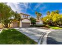 Spacious driveway leads to a three-car garage, complemented by mature landscaping and a blue sky backdrop at 1301 Kingdom St, Las Vegas, NV 89117