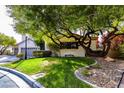 Charming home featuring mature trees providing plenty of shade on a well manicured lawn at 1301 Kingdom St, Las Vegas, NV 89117