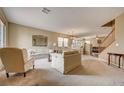 Spacious living room with neutral carpet, comfortable seating, and ample natural light at 2265 Stone Breeze Ave, North Las Vegas, NV 89031