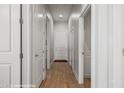 Bright hallway featuring white doors, wood floors, and recessed lighting creates a welcoming entrance into the home at 260 Haley Way # 157, Mesquite, NV 89027
