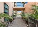Inviting front entrance with modern door, stylish planters, decorative rock, and a well-lit walkway at 39 Coralwood Dr, Las Vegas, NV 89135