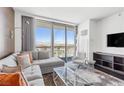 Bright living room with expansive city views, a comfortable sectional sofa, and modern decor at 4381 W Flamingo Rd # 38303, Las Vegas, NV 89103