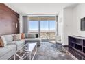 Inviting living room featuring city views, a gray sectional sofa, and stylish decor at 4381 W Flamingo Rd # 38303, Las Vegas, NV 89103
