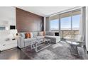 Bright living room featuring a comfortable sectional sofa, city views, and stylish decor at 4381 W Flamingo Rd # 38303, Las Vegas, NV 89103