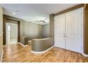 Hallway with laminate floors leading to secondary rooms and closet at 4956 Momenti St, Las Vegas, NV 89135