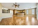 Spacious living area with hardwood flooring, ample natural light, and an open floor plan to the kitchen at 4956 Momenti St, Las Vegas, NV 89135